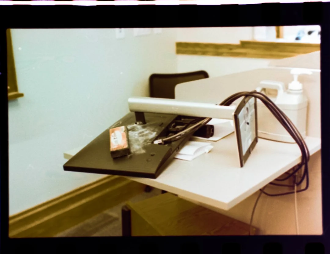 Spacious and contemporary office interior with glass partitions, stylish furniture, and vibrant wall art.
