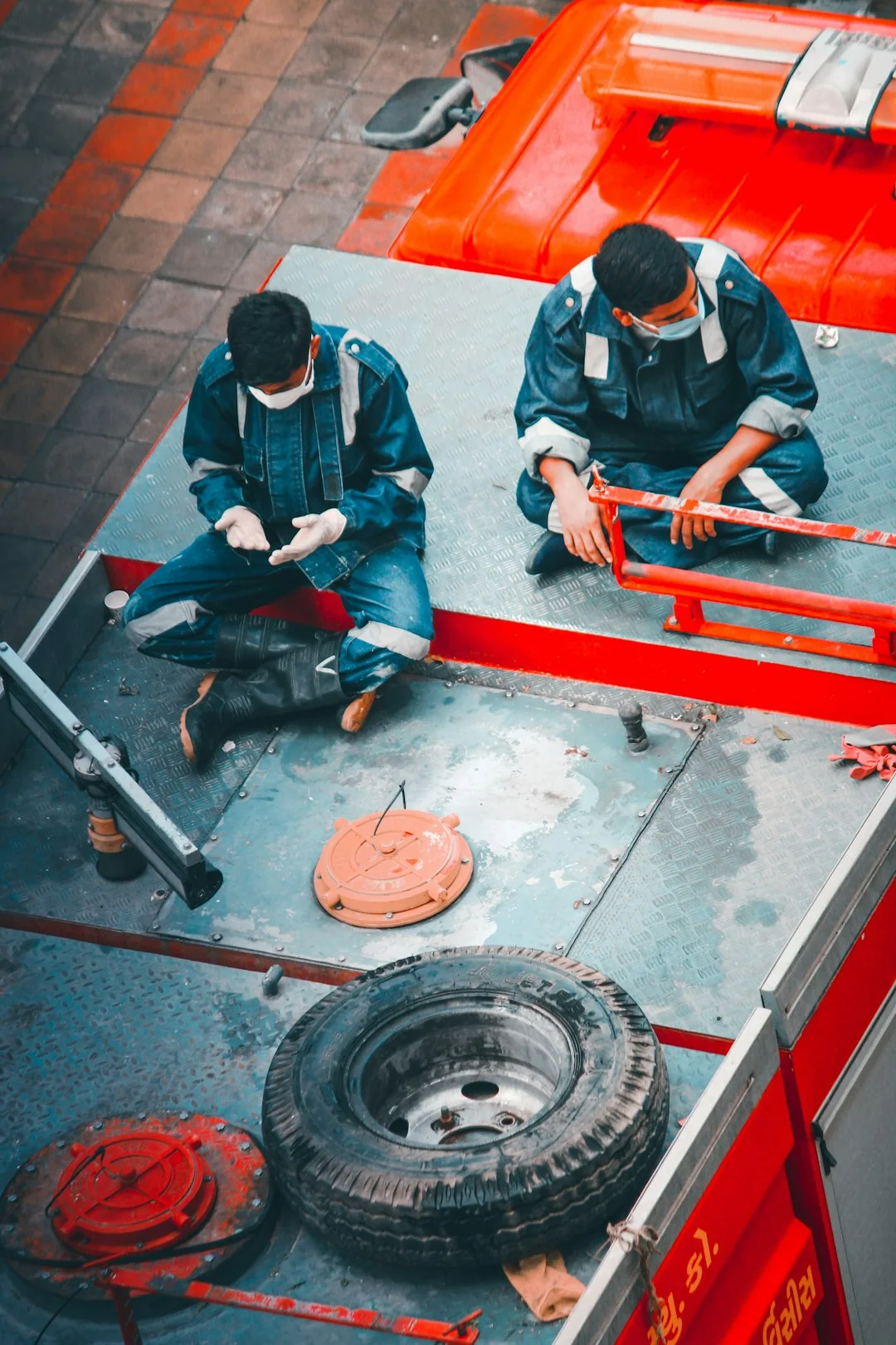 An individual disinfects a workspace using fumigation, wearing full protective gear for safety.